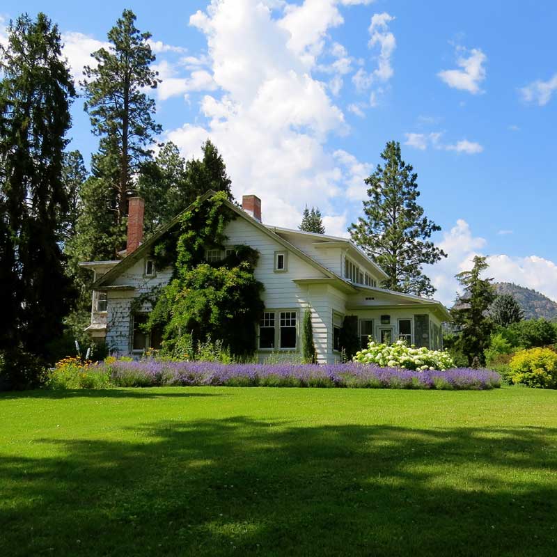 house-surrounded-by-green-grass-below-clouds-and-sky-226407
